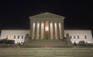 front of Supreme Court building illuminated against night sky