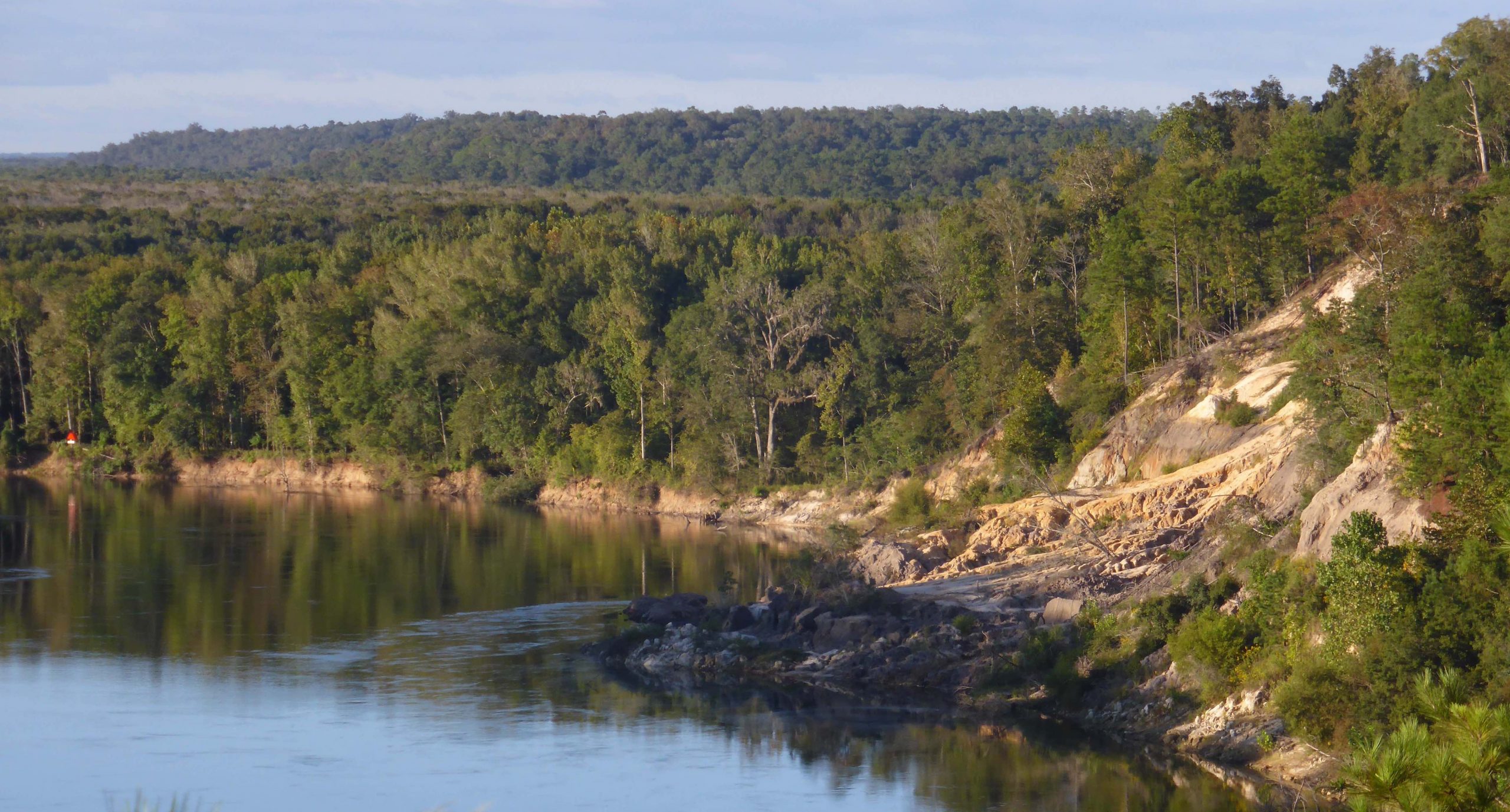 curving river surrounded by forest-covered hills