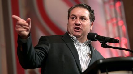 Mark Brnovich pointing while speaking at microphone