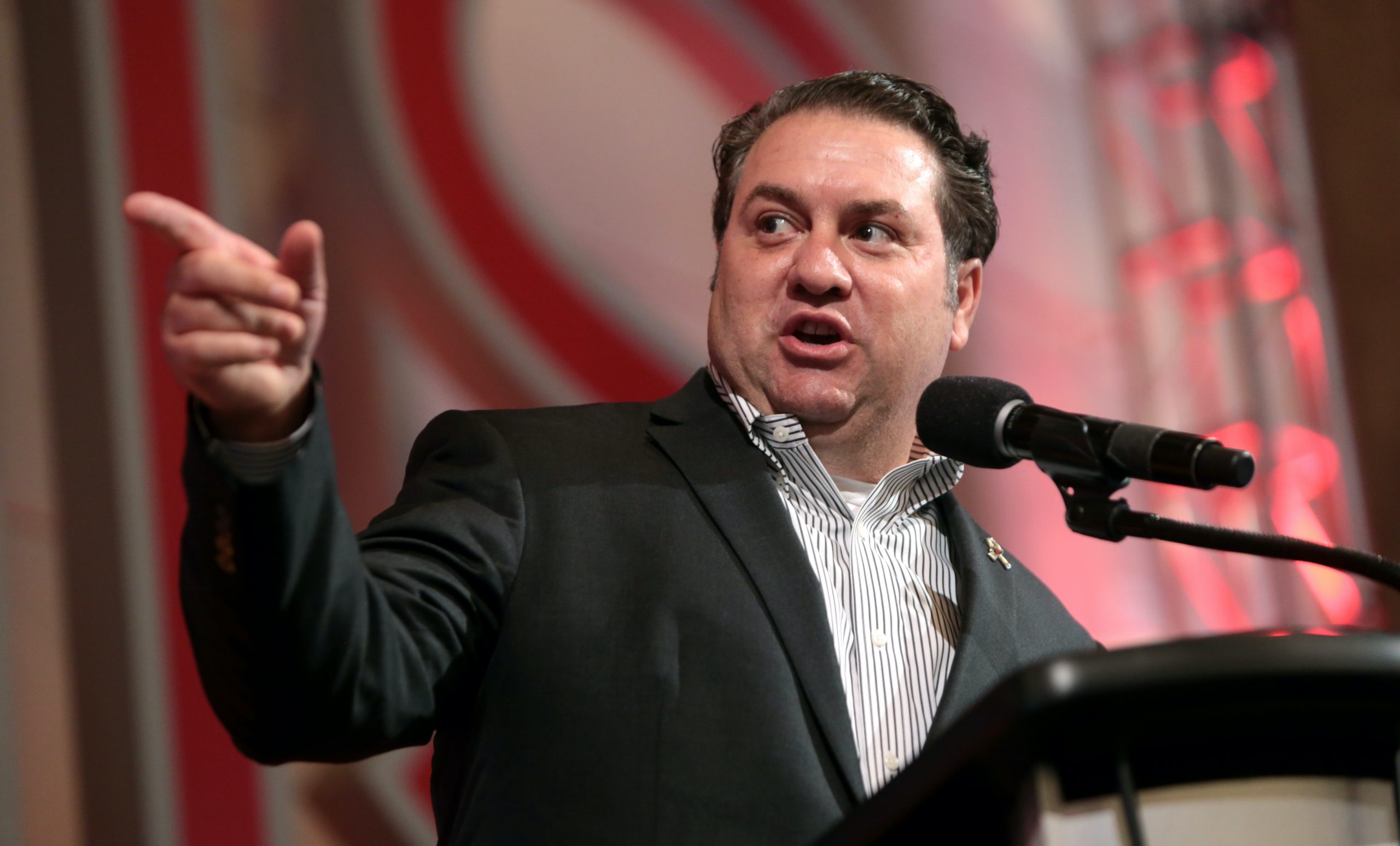 Mark Brnovich pointing while speaking at microphone