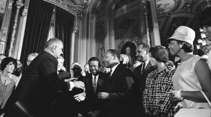 Lyndon Johnson, Martin Luther King Jr. and Rosa Parks among crowd of people