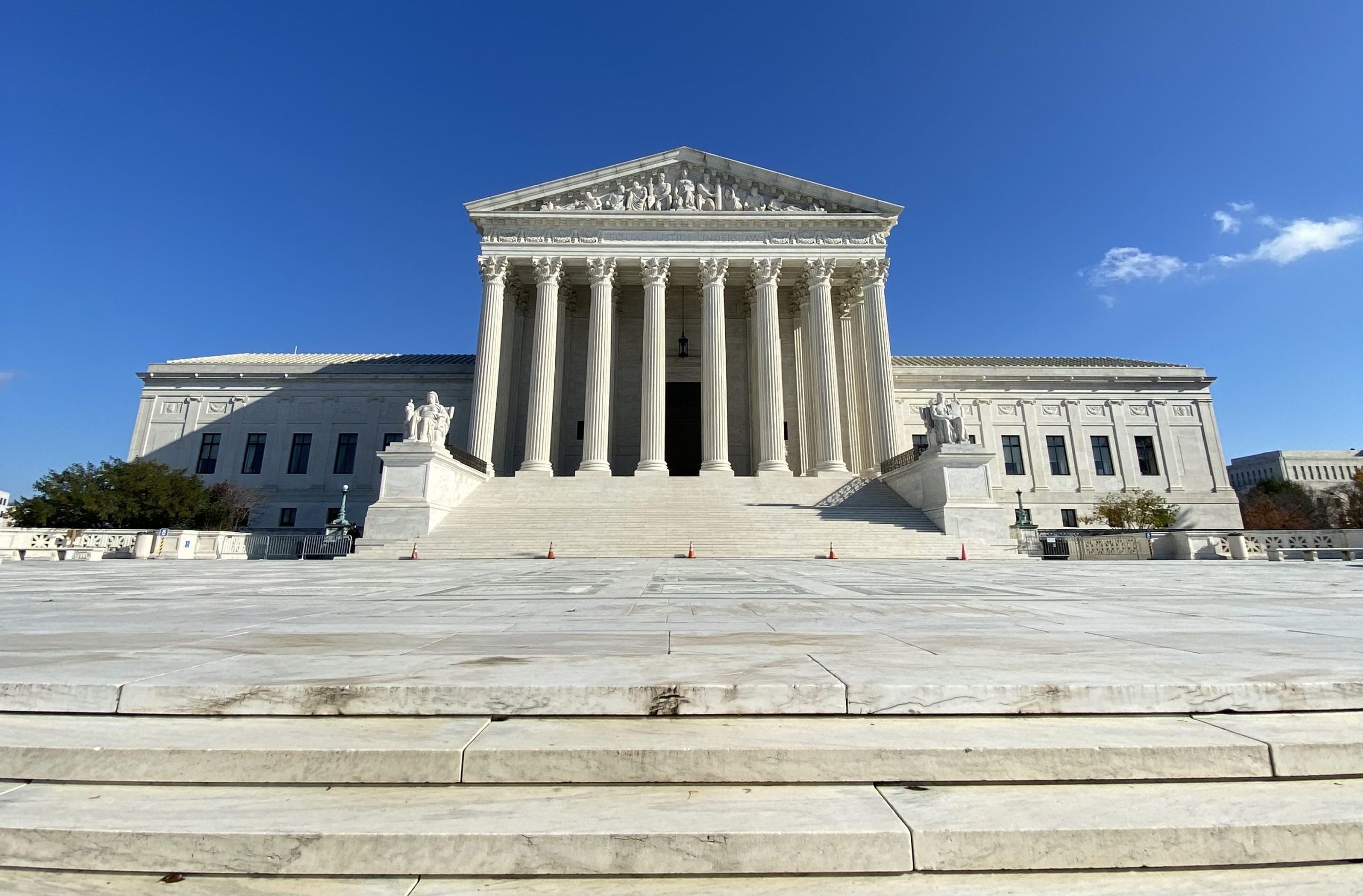 front facade of Supreme Court a،nst blue sky