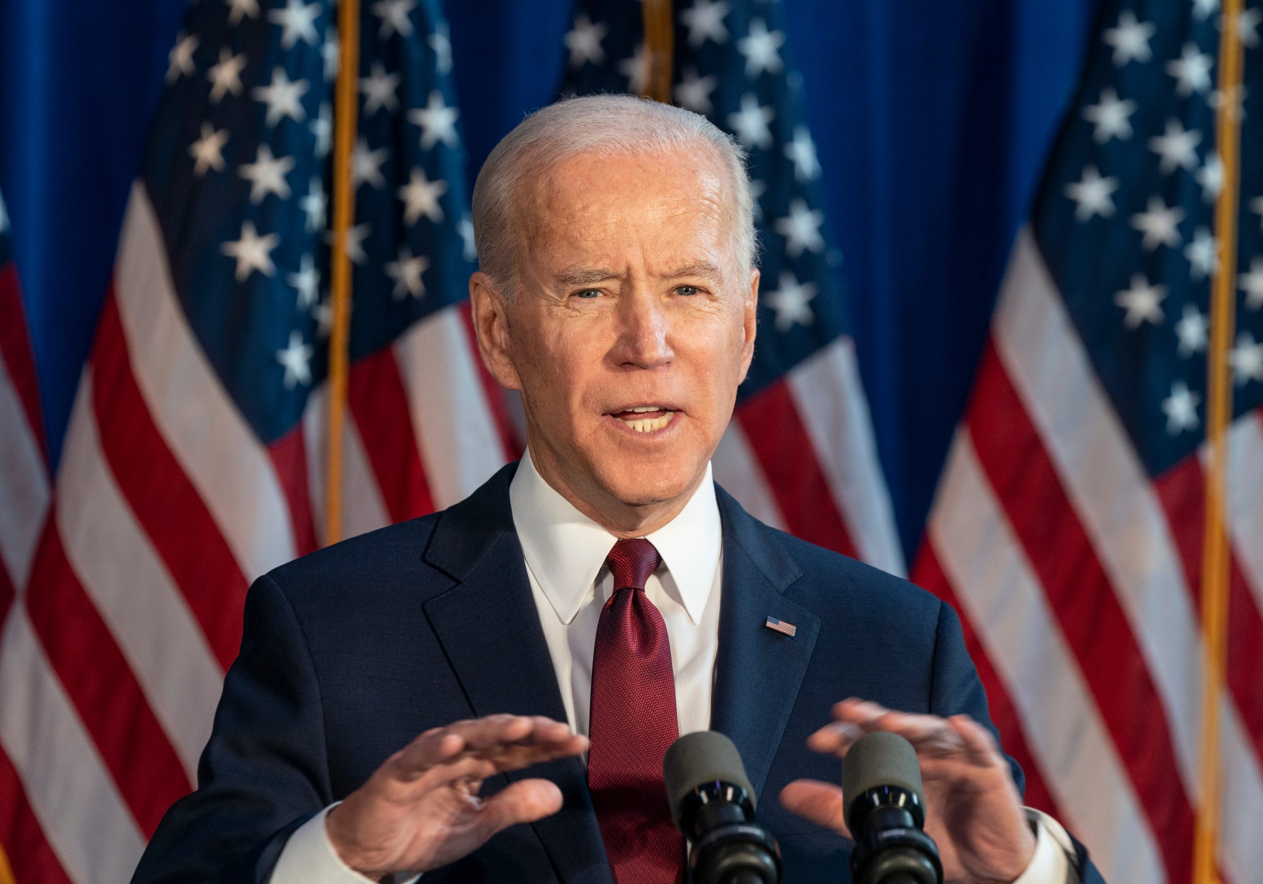 joe biden speaking at microphone