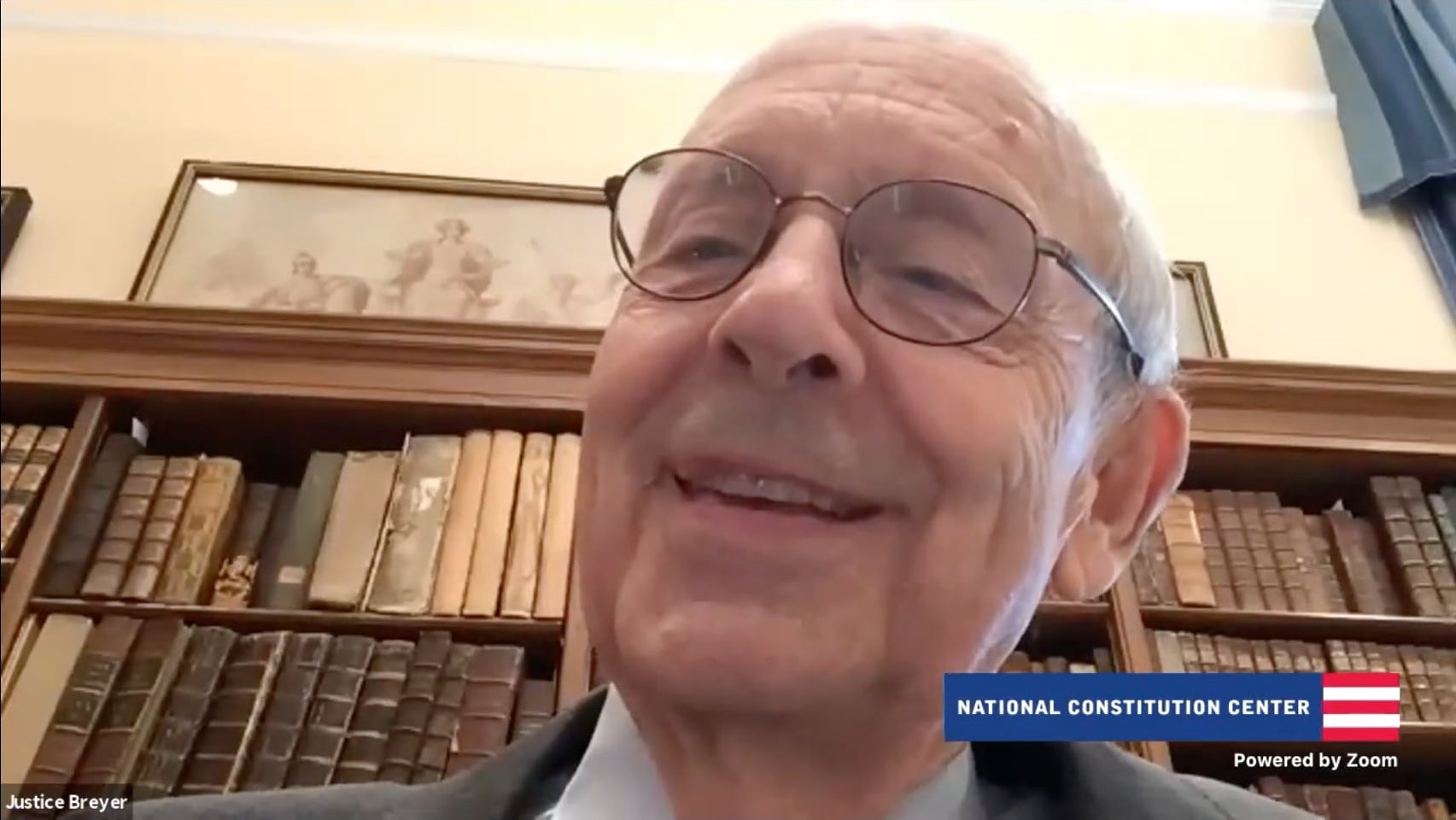 Screenshot of Stephen Breyer's face with bookcase in background and National Constitution Center logo on screen
