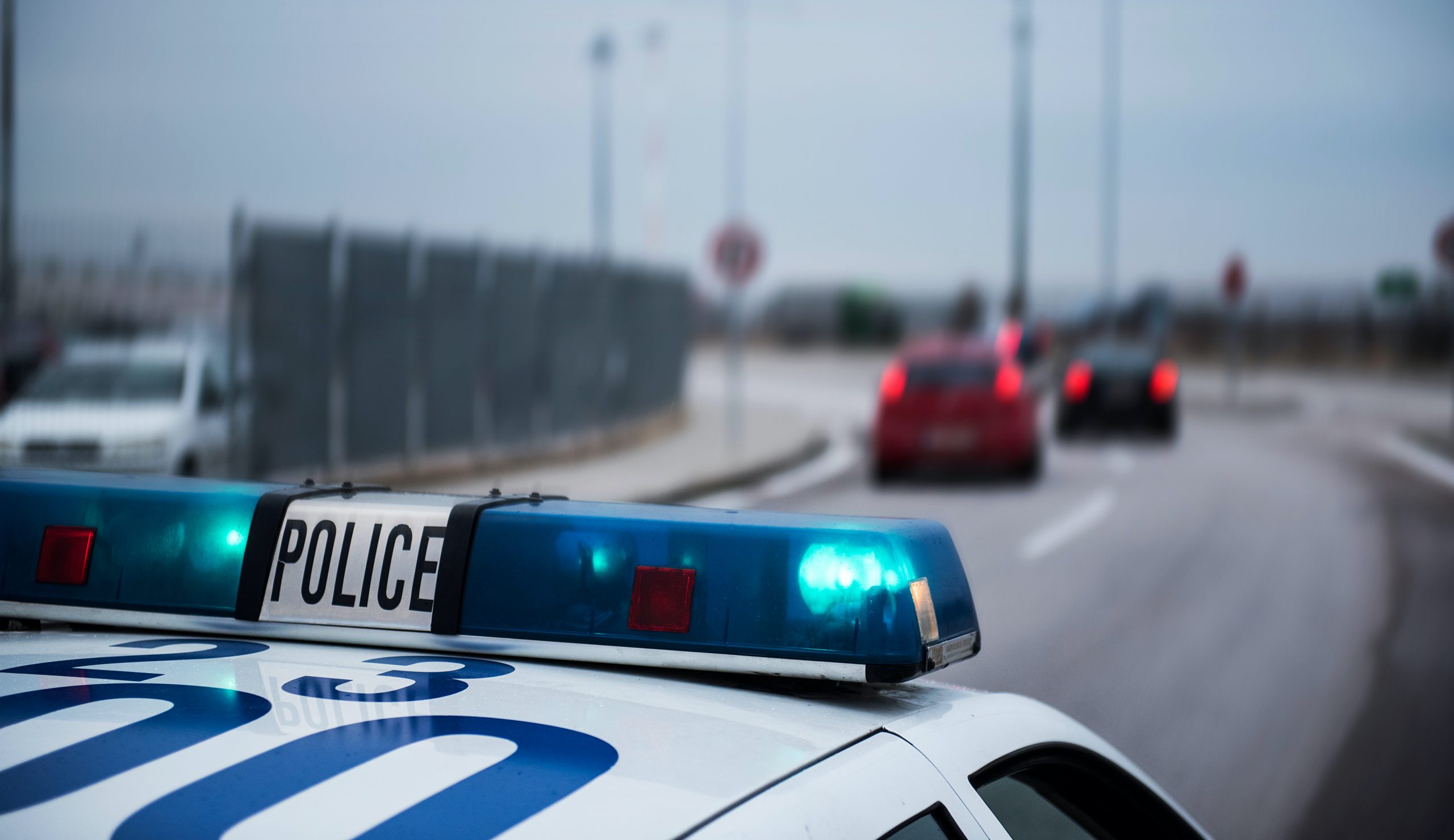 Police car following cars inside a city with motion blur effect