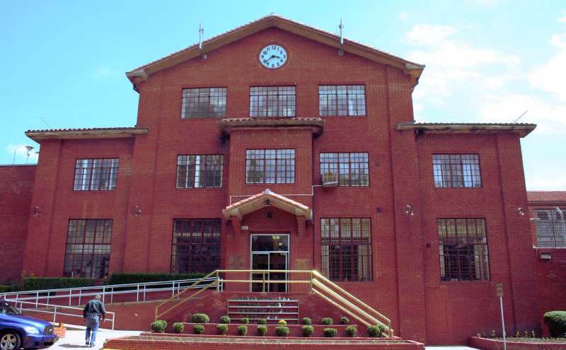 large three-story brick building with windows