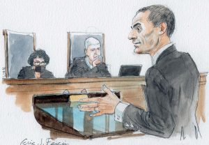 man at lectern gesturing with left hand; justices sotomayor and gorsuch in background