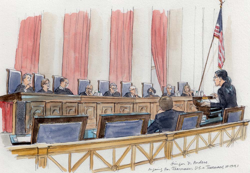 woman at lectern speaking to nine justices sitting on elevated bench