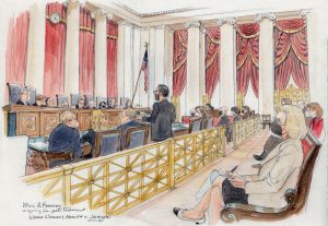 wide view of courtroom showing man standing at lectern, justices on bench in background, several lawyers sitting at counsel's table, and journalist taking notes in foreground