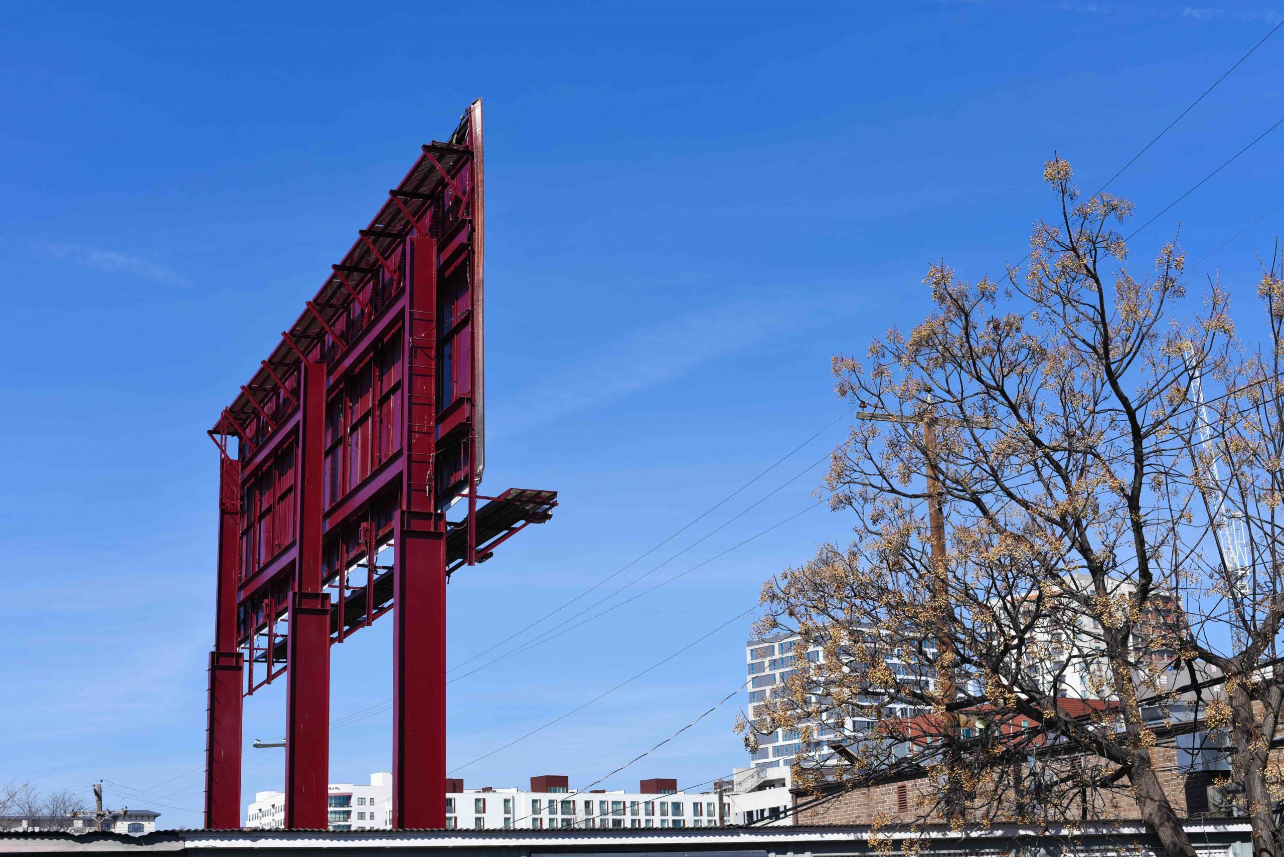 large red billboard seen from back against blue sky