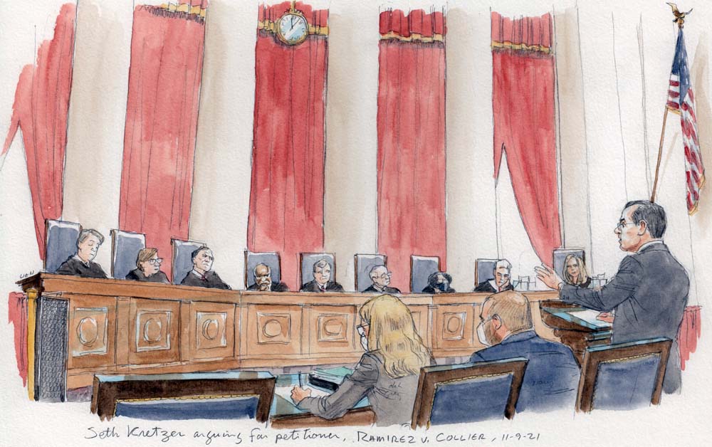 All nine justices on the bench, a lawyer at the lectern speaks while his two colleagues sit to his side, taking notes.