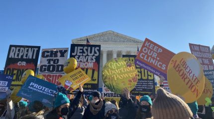 Protest signs in front of the Supreme Court