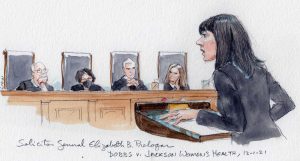 Elizabeth Prelogar arguing at the lectern in front of four justices