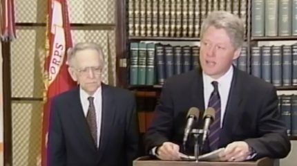 bill clinton speaking at lectern with harry blackmun standing beside him