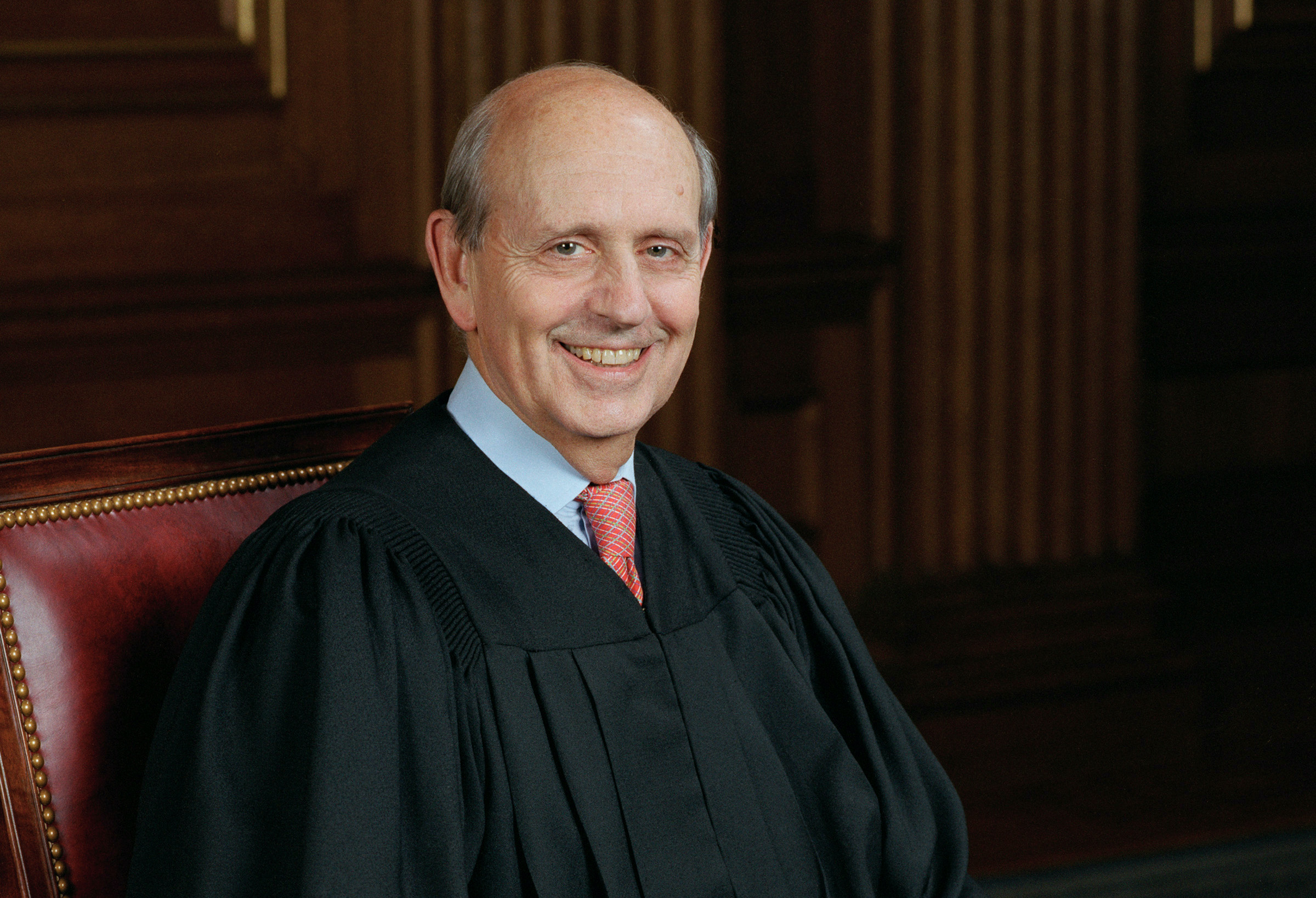 stephen breyer in black robe smiling at camera