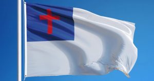 mostly white flag with red cross surrounded by blue square in upper left quadrant