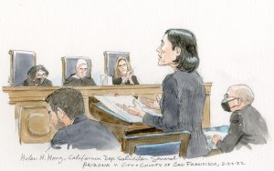 Three justices watch as woman speaks at the lectern, flanked by two seated men