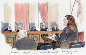 Woman at lectern arguing before five of the justices