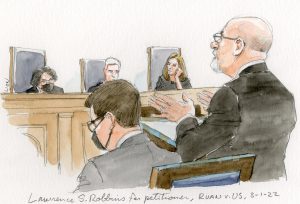 man in glasses argues before three inquisitive justices