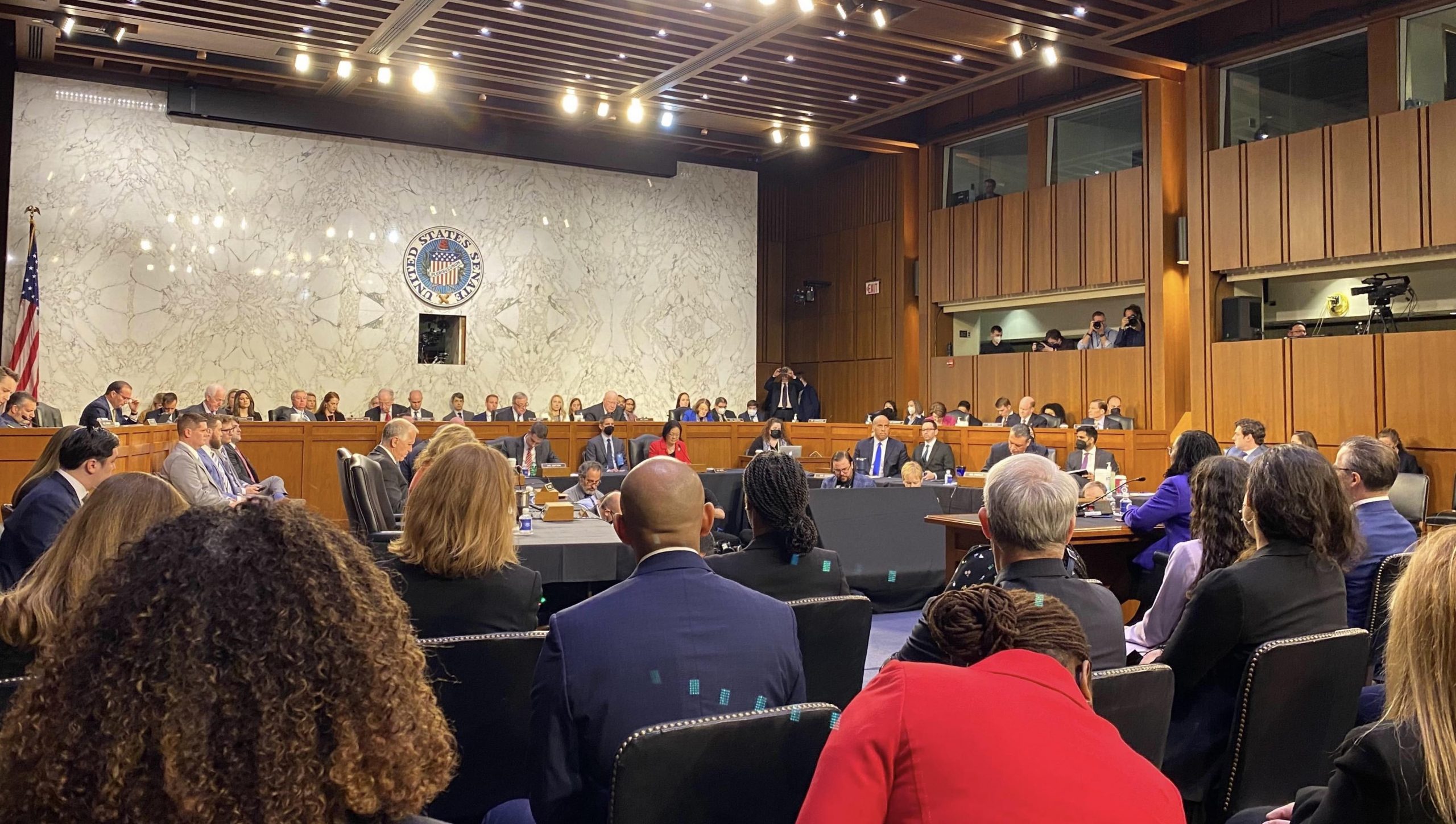 wide shot of crowded hearing room with senators on dais and ketanji brown jackson sitting at table