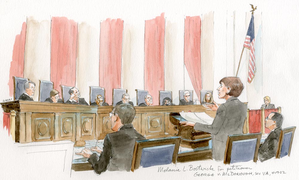 Woman speaking before all nine justices on the bench