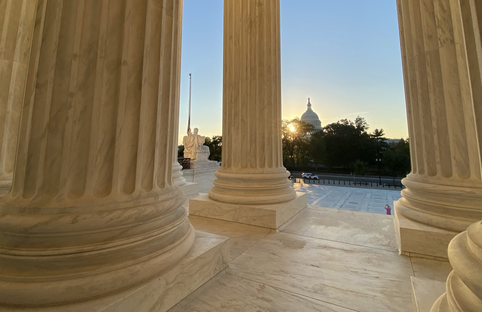 View of U.S. Capitol with sunset from Supreme Court steps