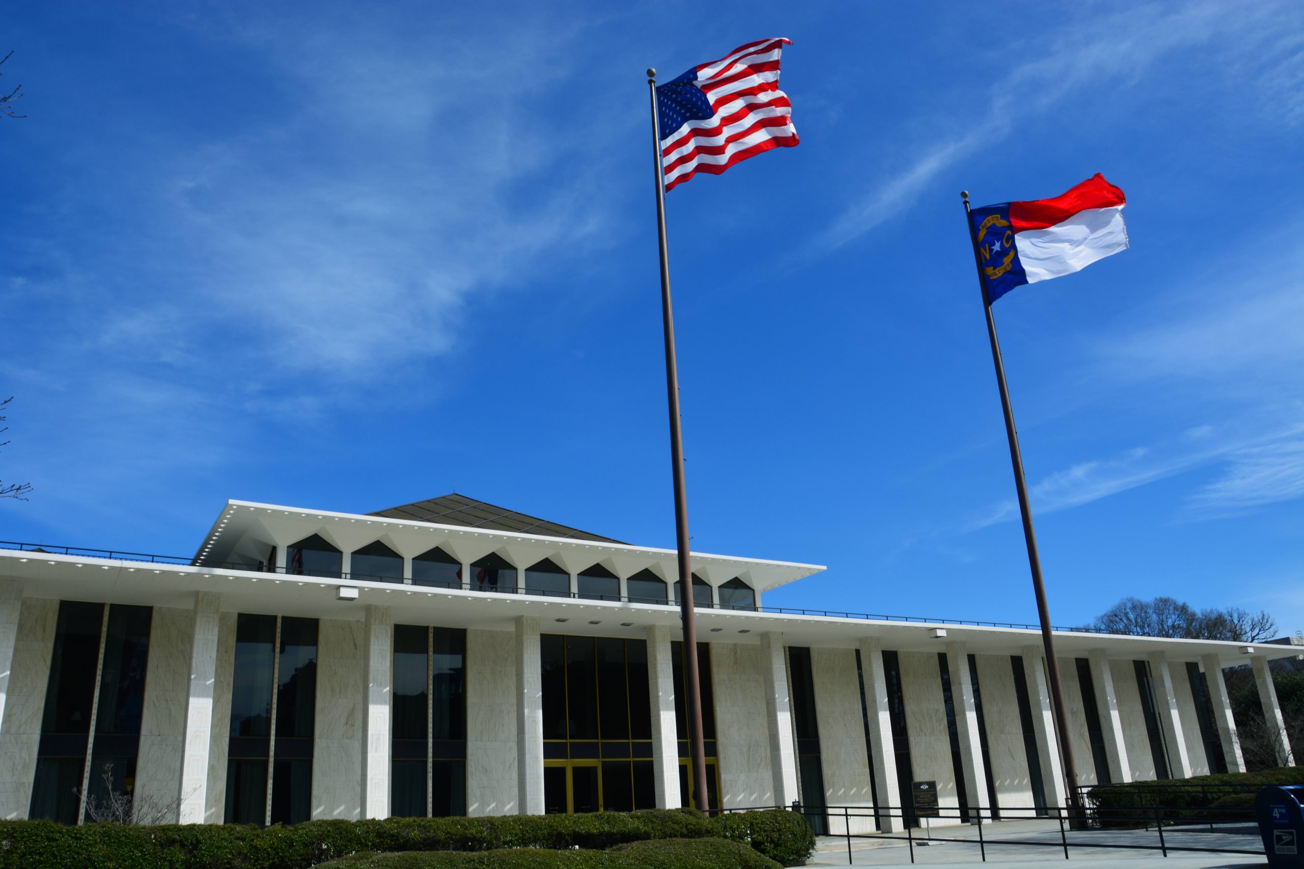 The North Carolina Legislative Building with the North Carolina and U.S. flags flying