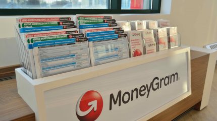brochures and financial forms are arranged on a display counter
