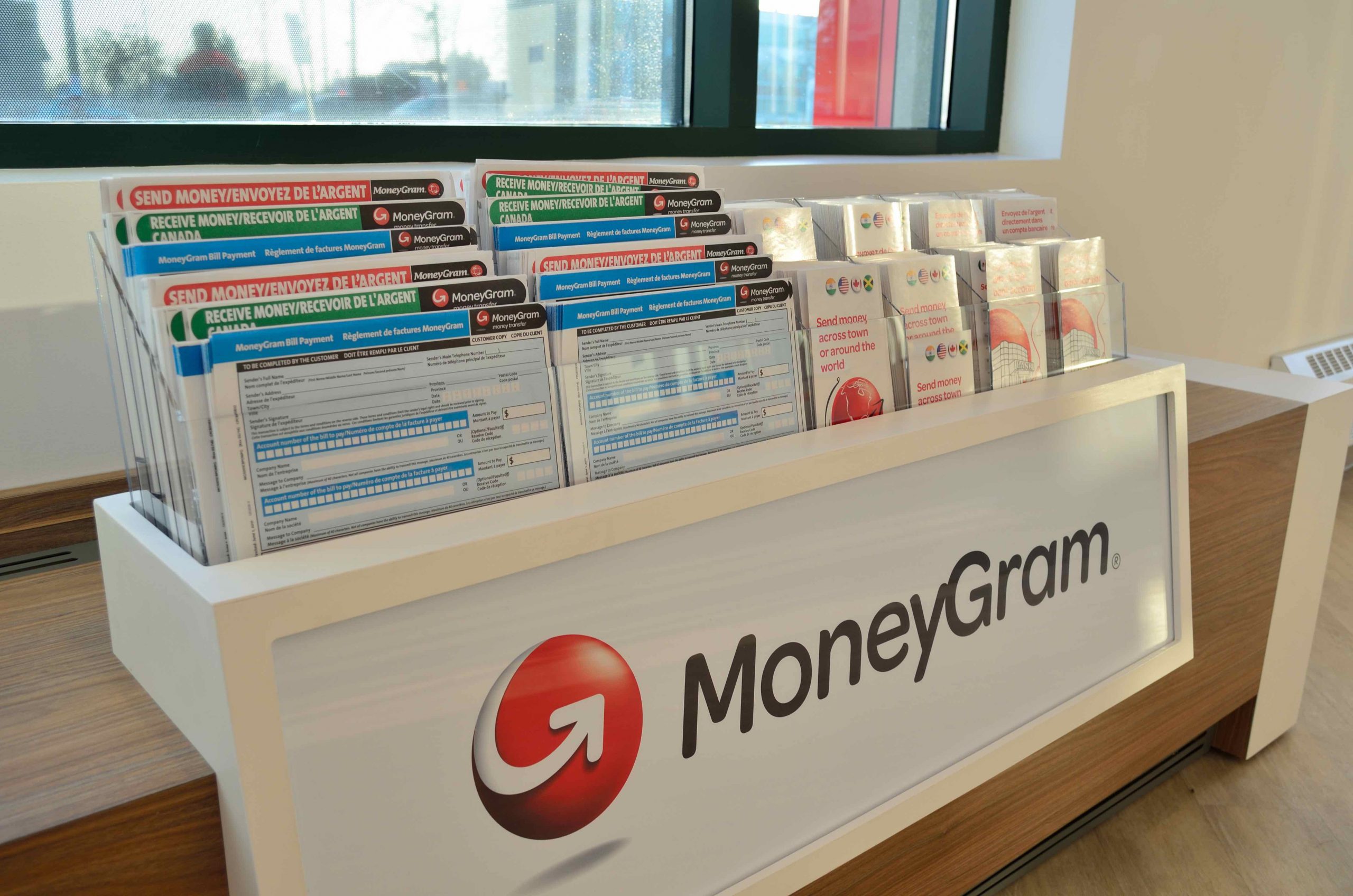 brochures and financial forms are arranged on a display counter