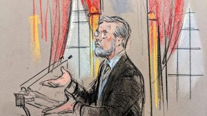 Sketch of bespectacled man with beard gesturing before the podium,