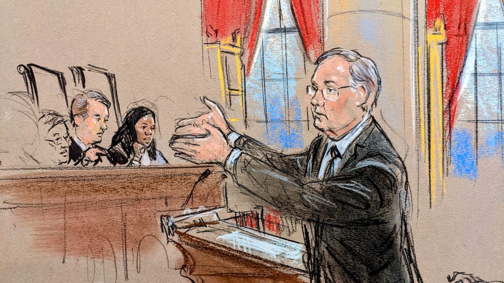 sketch of bespectacled man gesturing with both hands before the podium.