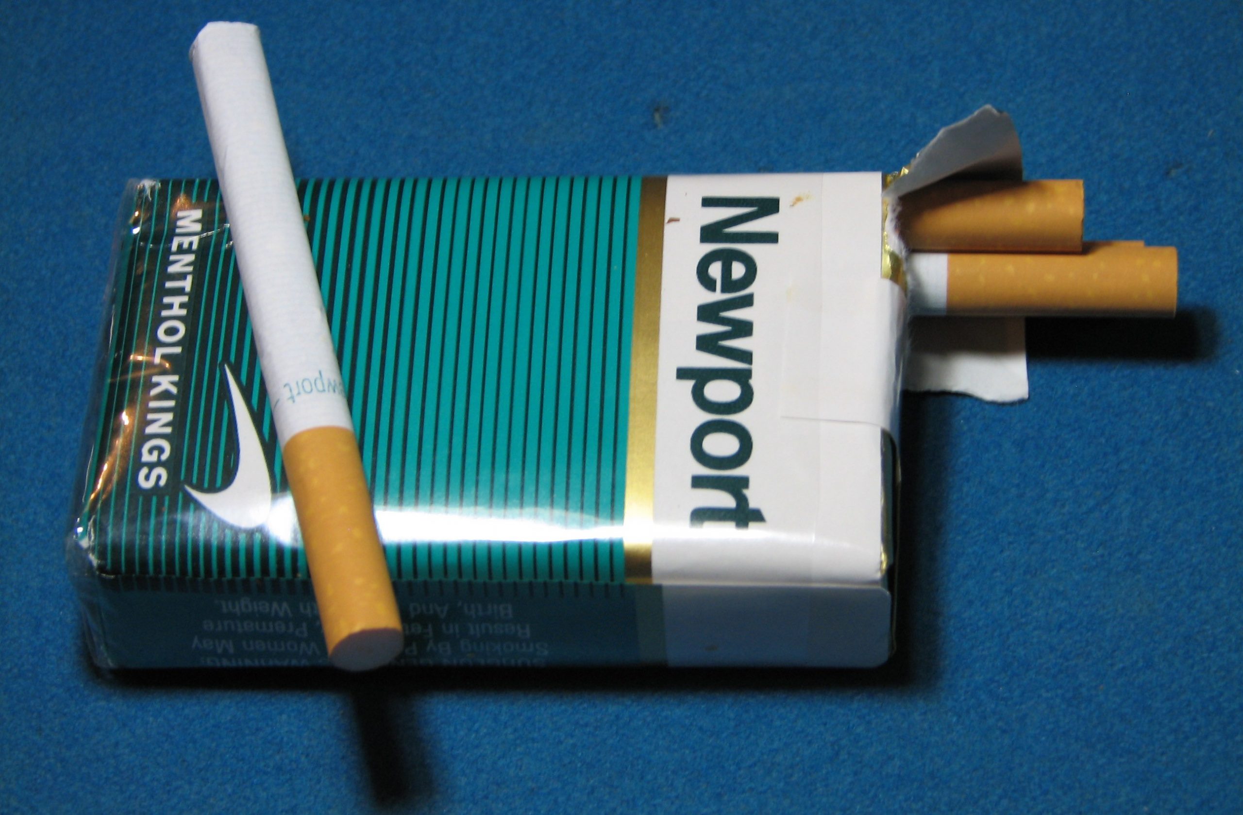 opened cigarette pack with Newport logo. one loose cigarette.