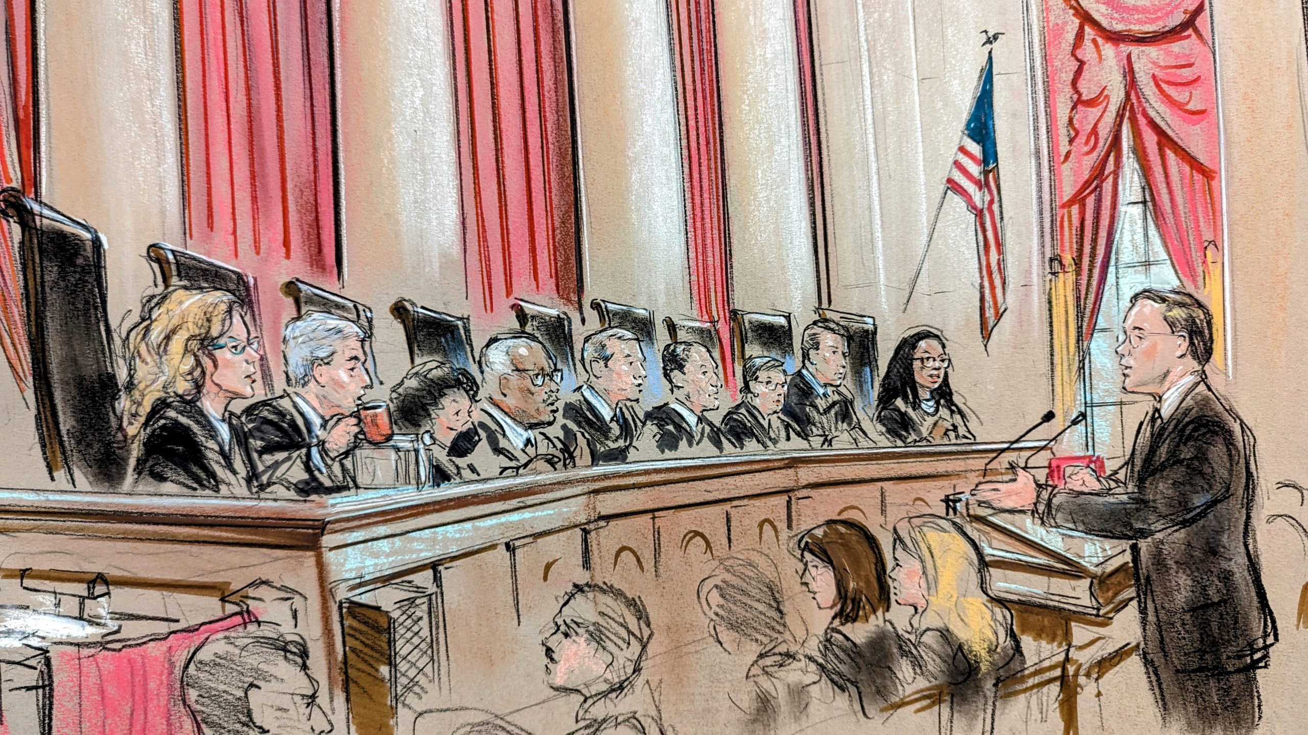 Sketch of a man in spectacles arguing before a full bench. Justice Barrett sports blue glasses, and Justice Gorsuch drinks coffee from an orange mug.
