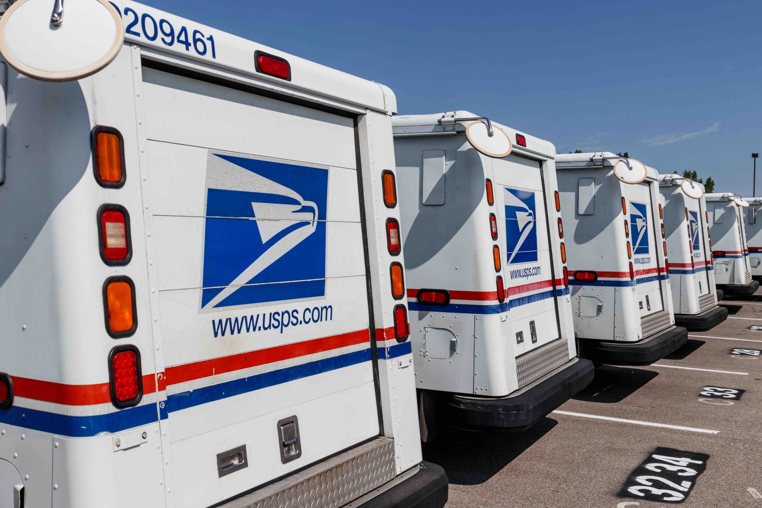 rear view of a line of parked mail trucks
