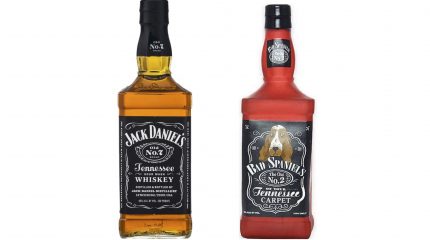 A bottle of Jack Daniel's whiskey next to a dog toy shaped to resemble the bottle