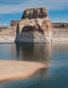 Large sandstone "Lone Rock" in the middle of a pool of water