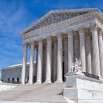 Justices debate propriety of litigation in trial courts while defendants are on appeal seeking arbitration