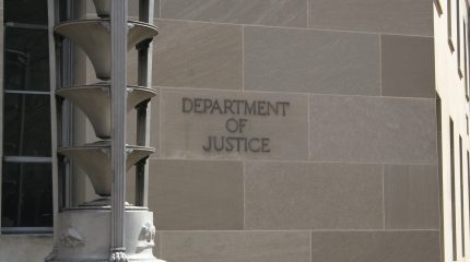 Department of Justice sign on a stone building