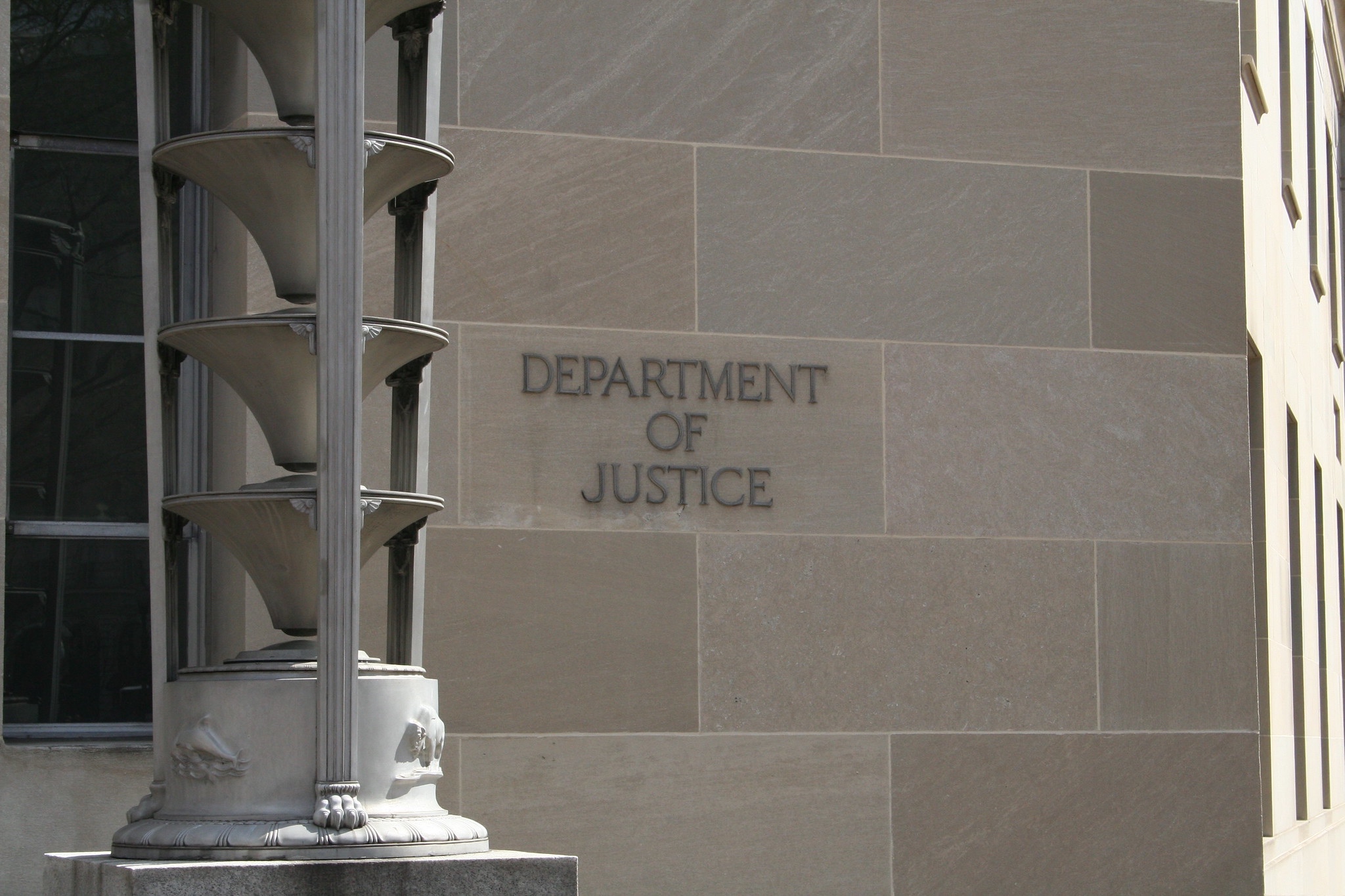 Department of Justice sign on a stone building