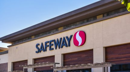 The outside of a Safeway store with the company's name and logo