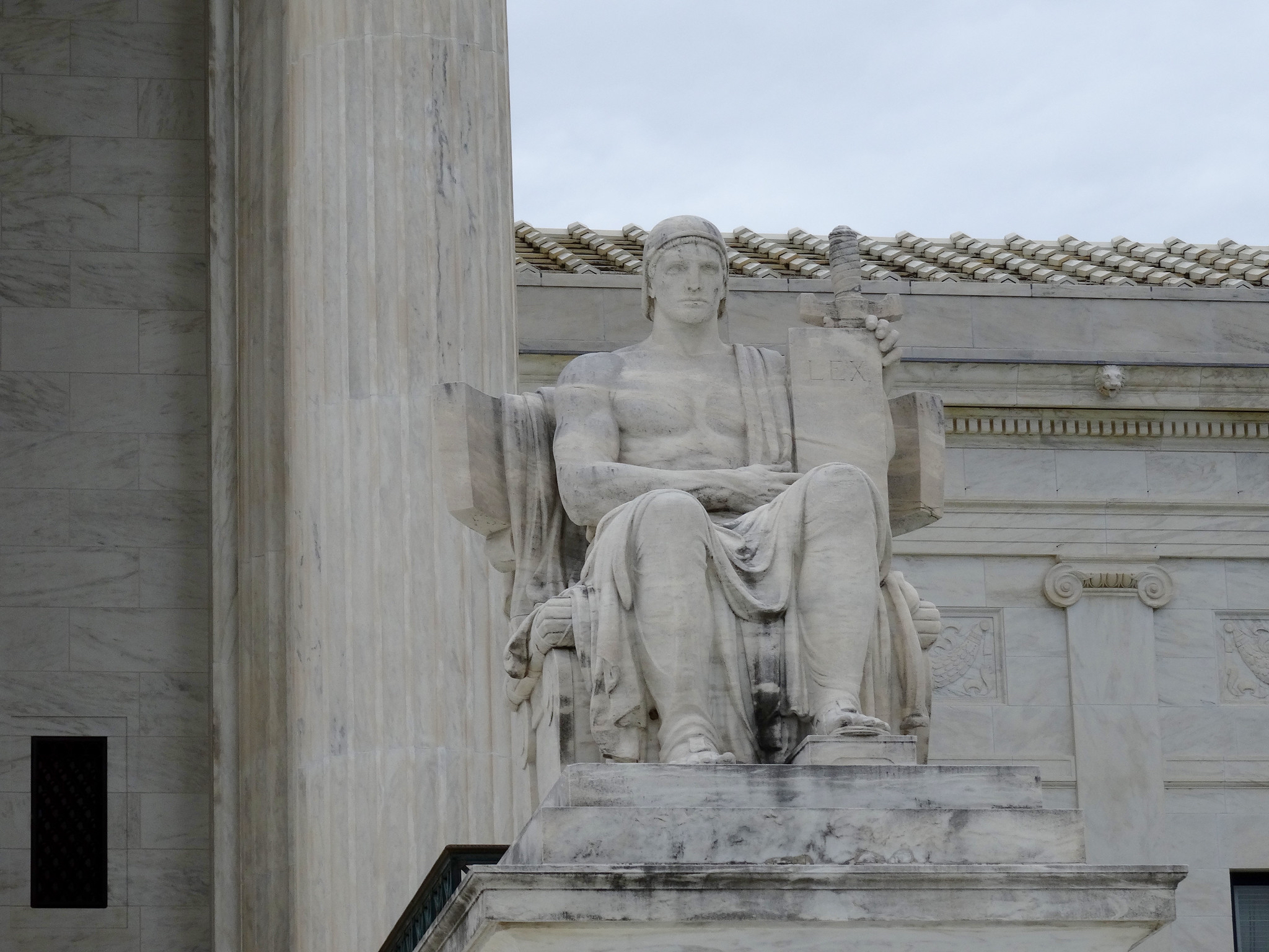 The statute of a seated man outside the Supreme Court