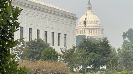 The Supreme Court and Capitol buildings under a haze of wildfire smoke