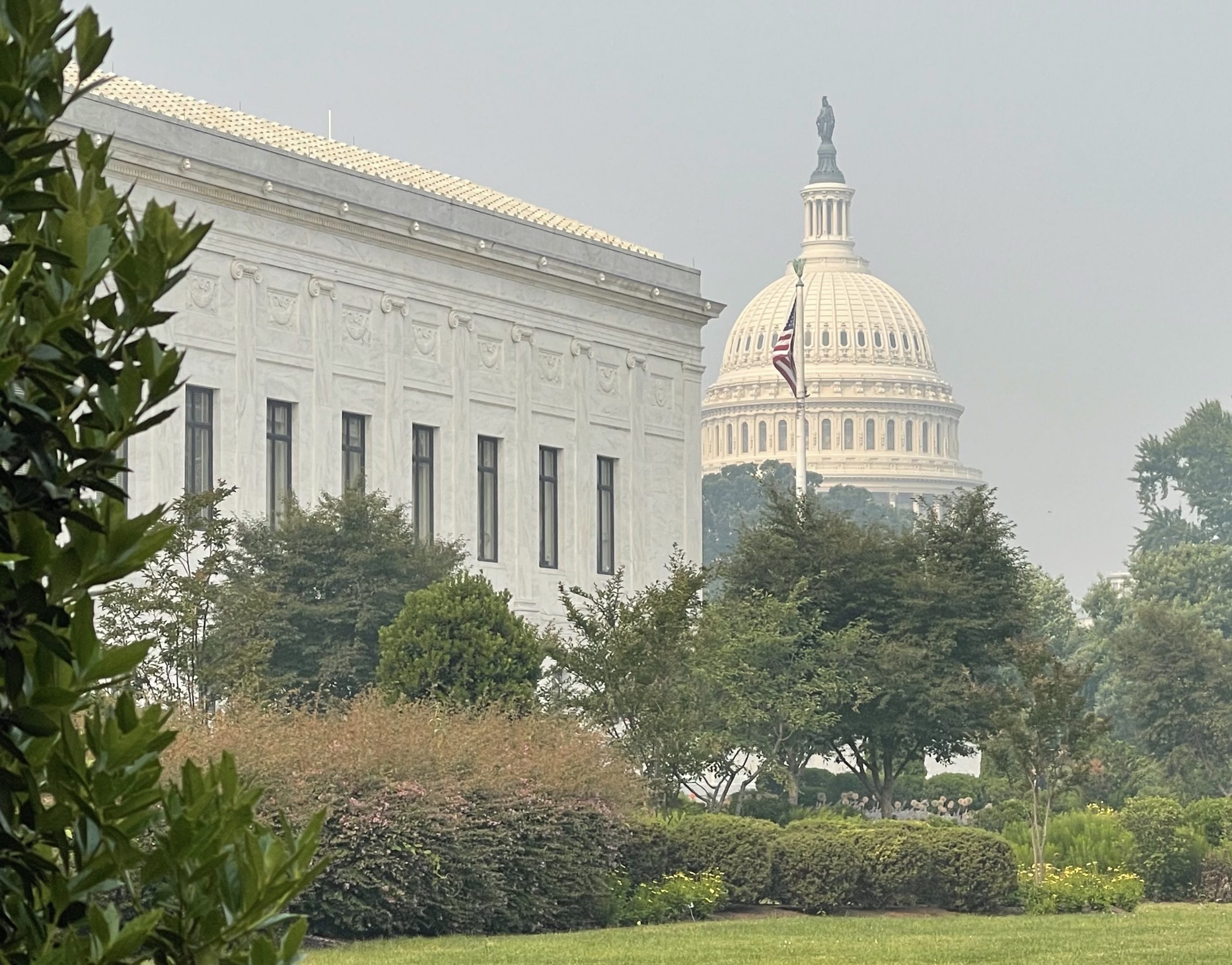 The Supreme Court and Capitol buildings under a haze of wildfire smoke