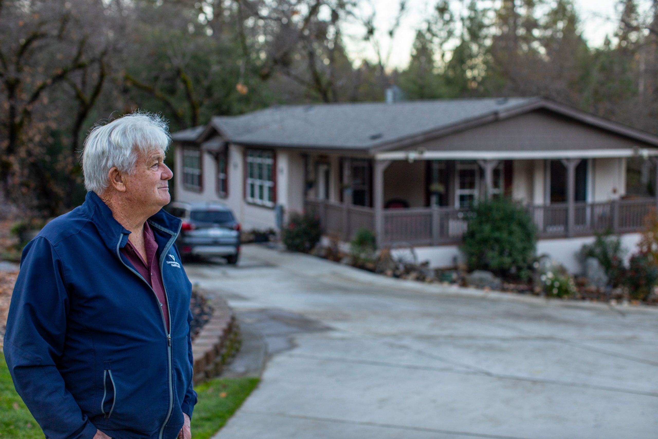 Man standing in front of a one-story home.