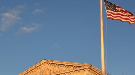 An American flag flies over the Supreme Court