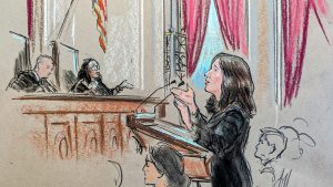 Woman speaking to two justices on the bench 
