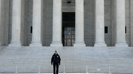 Police officer standing on the Supreme Court steps