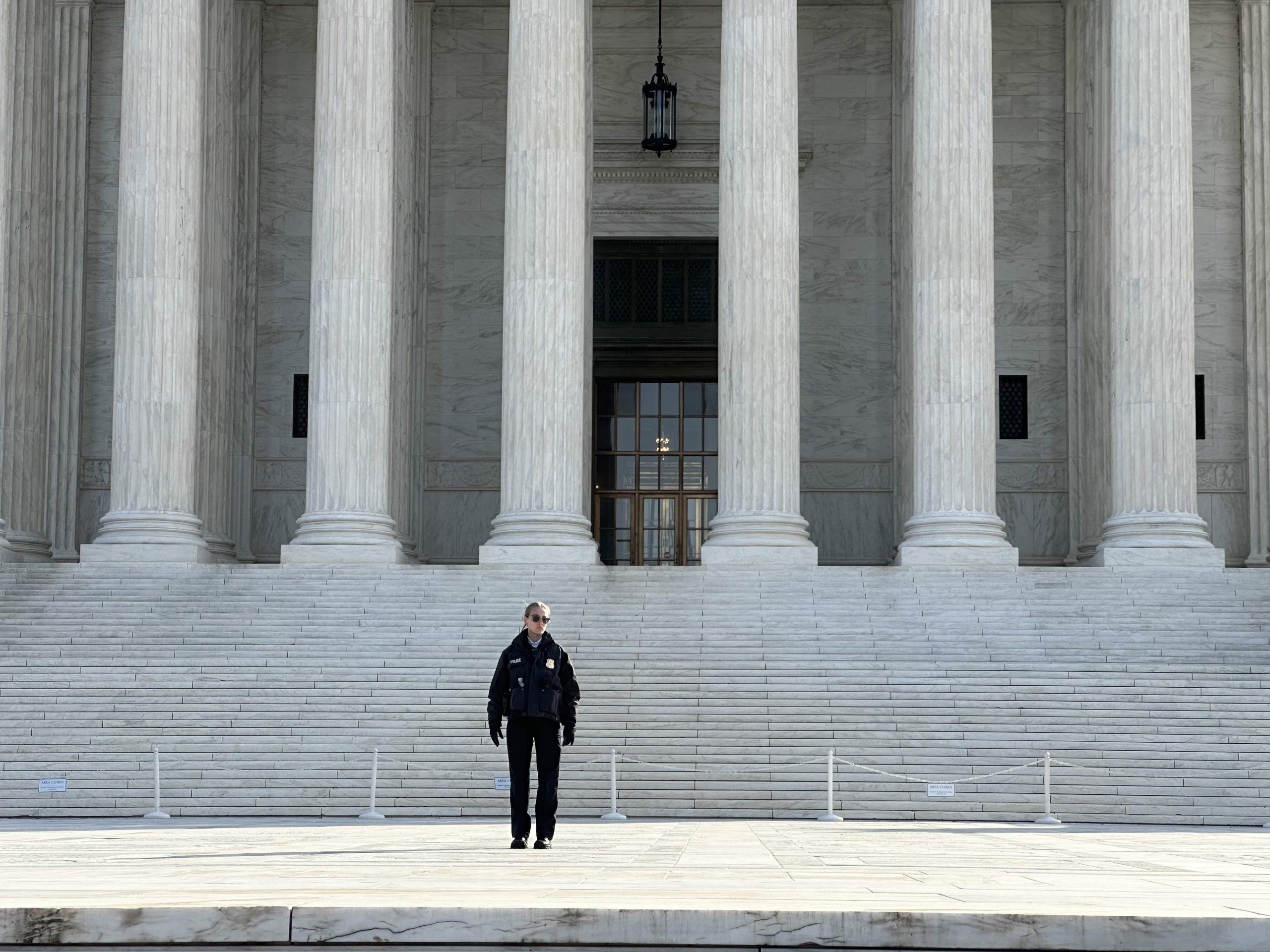 Police officer standing on the Supreme Court steps