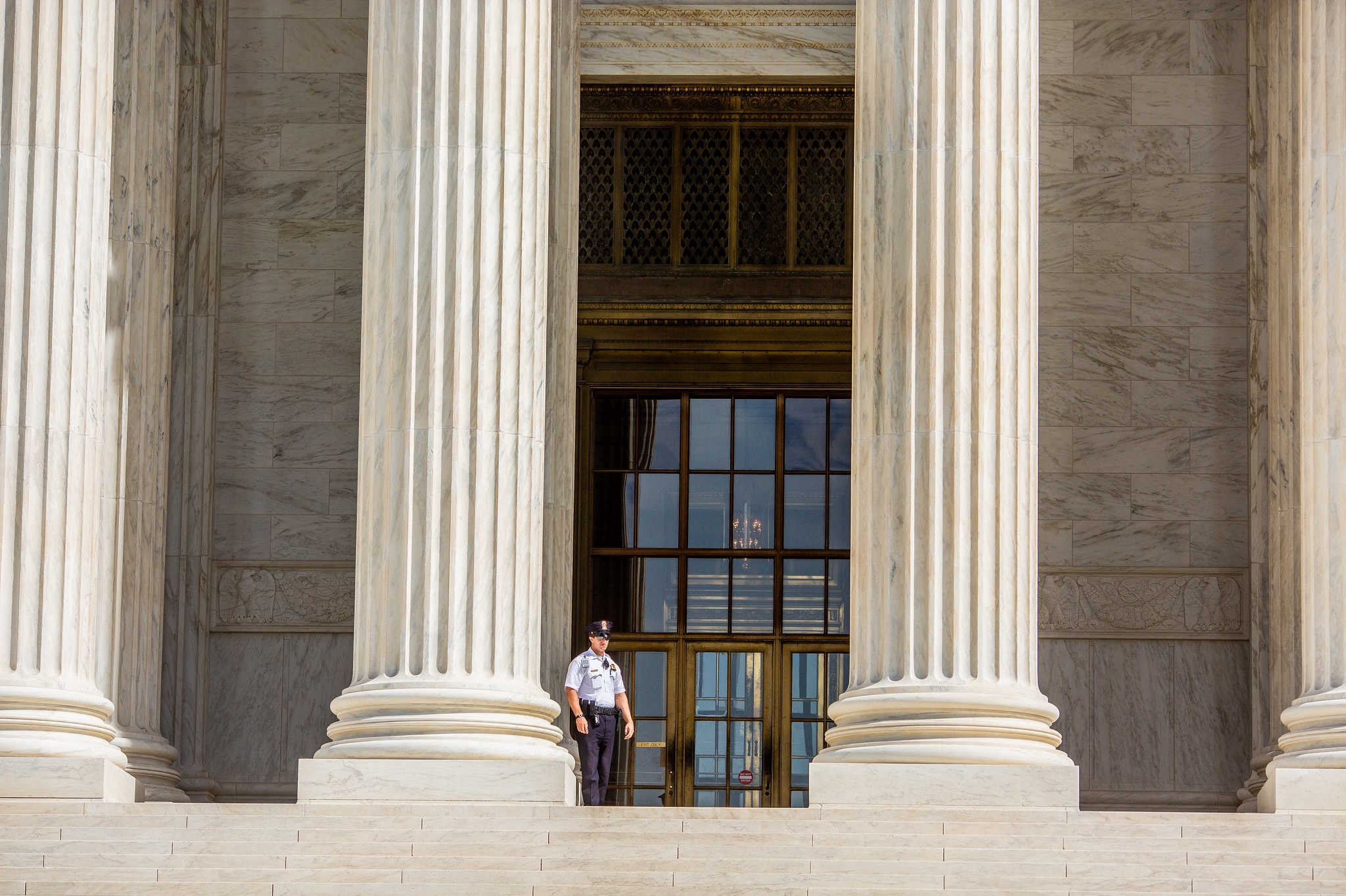 Guard standing on the Supreme Court steps.