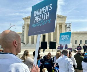 Protesters holding signs that read "Women's Health Matters" outside the Supreme Court